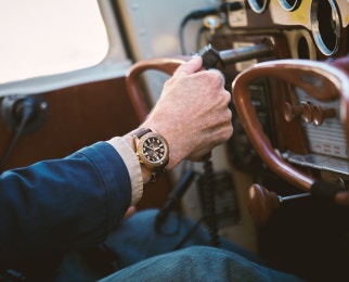 person driving wearing shinola bronze monster gmt watch