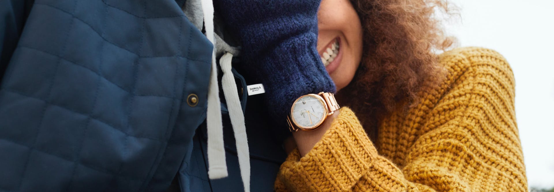 Woman smiling, wearing a Shinola watch