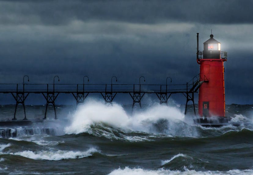 Waves crashing around a lighthouse